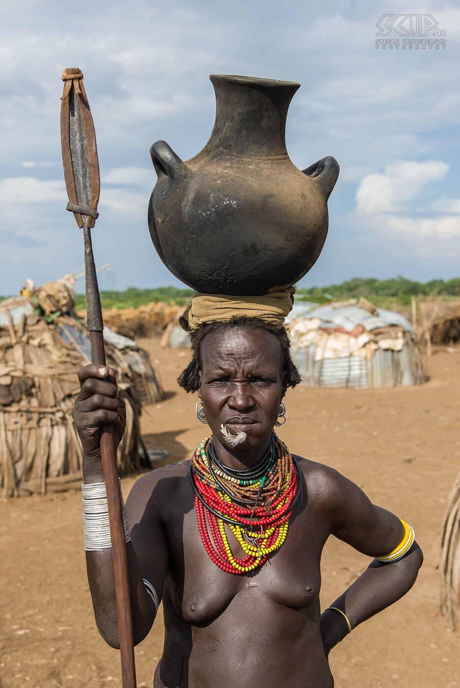 Omorate - Dassanech woman From Turmi we drove to Omorate near the border with Sudan and there we crossed the Omo river with a dugout canoe. <br />
<br />
On the other side we visited a village of the Dassanech/Daasanach also known as Galeb or Geleb. The Dassanech are agropastoral people and they build simple igloo huts with wood and corrugated iron plates. Their greatest asset is their cattle. They also grow sorghum, maize and beans.<br />
<br />
The government is building a bridge on the Omo river, so in the next years many people, cars and trucks will pass the Dassanech villages. I’m quite sure that this will change their way of life. Stefan Cruysberghs